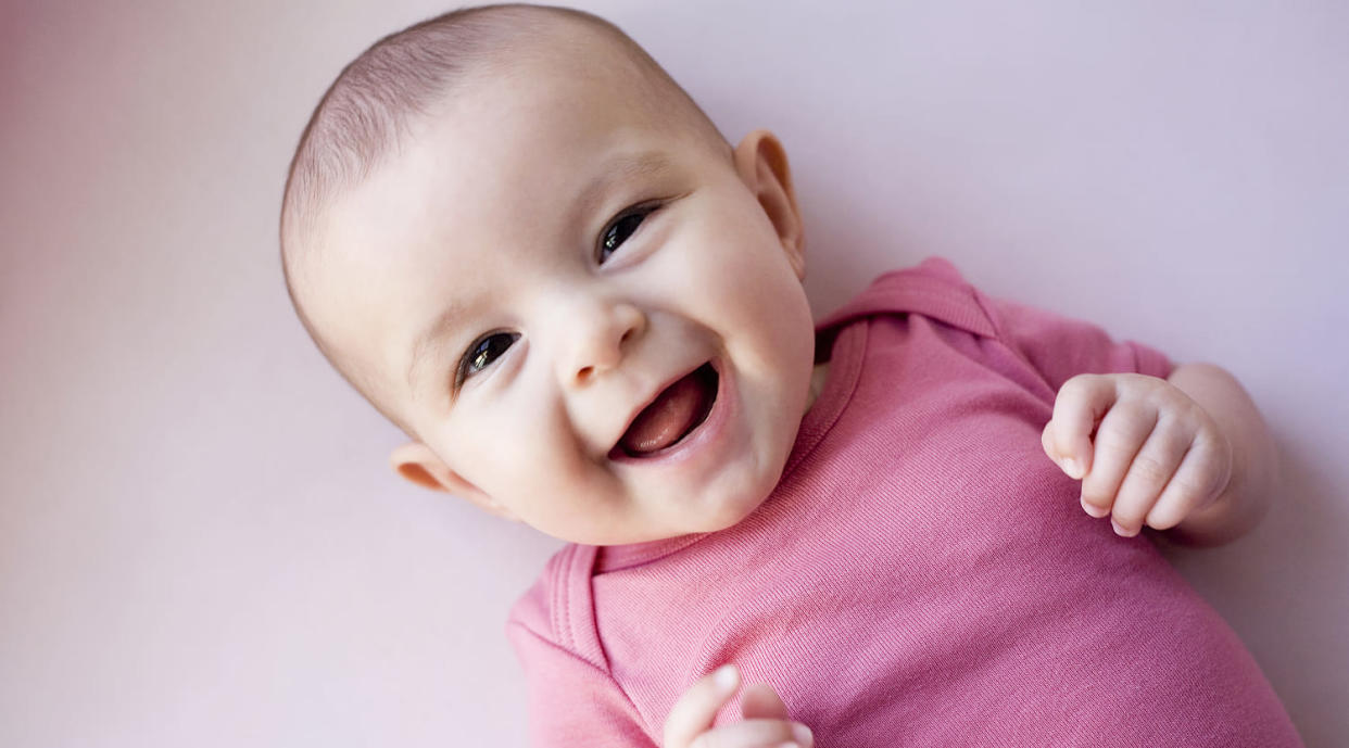 Baby girl laughing (Cecile Lavabre / Getty Images)