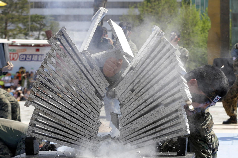 A soldier from the South Korean army special forces breaks stone plates with his hand during a martial arts demonstration for Children’s Day at the War Memorial of Korea in Seoul, South Korea, May 5, 2016. In South Korea May 5 is celebrated as Children’s Day, a national holiday. (Ahn Young-joon/AP)