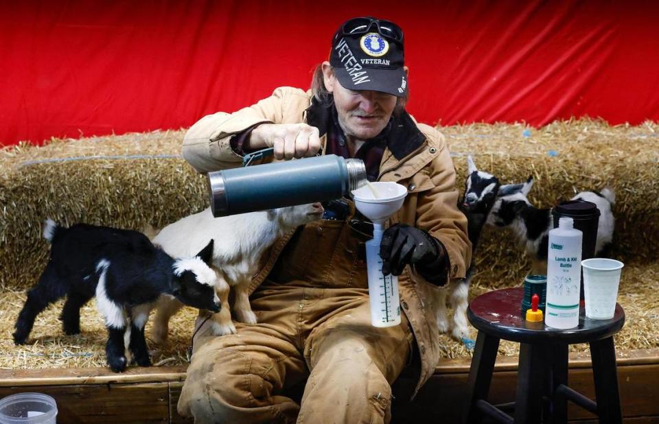 James Milam, 64, prepares a bottle to feed kid goats at the the photo stand at the entrance of the Sheep Barn at the Fort Worth Stock Show & Rodeo. The photo stand, operated by LBR Ranch for 39 years, offers photos with goat kids or ponies. Milam says he prefers then Nigerian goats with their pointy ears.