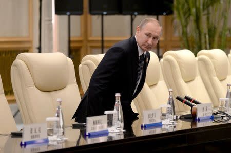 Russian President Vladimir Putin meets with Chinese President Xi Jinping (not in picture) ahead of the G20. REUTERS/Wang Zhao/Pool