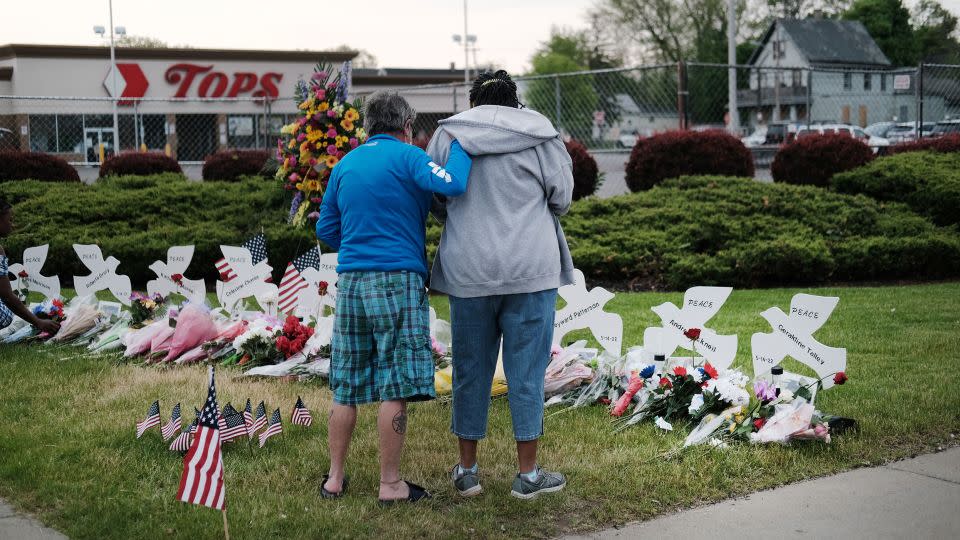 People gather at a memorial for the shooting victims outside of Tops supermarket on May 20, 2022, in Buffalo, New York. - Spencer Platt/Getty Images