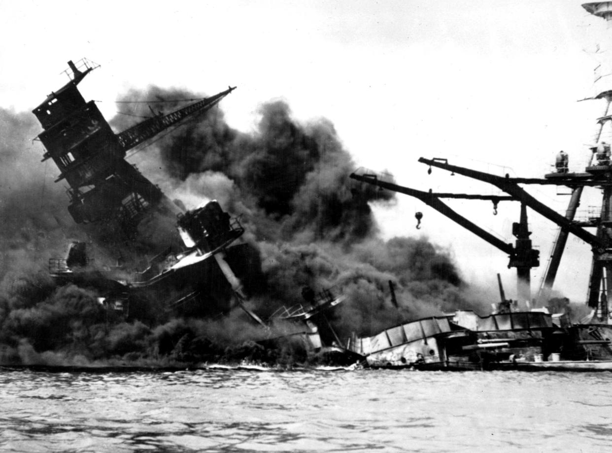 AP File
The battleship USS Arizona belches smoke as it topples over into the sea during a Japanese surprise attack on Pearl Harbor, Hawaii, Dec. 7, 1941. The ship sank with more than 80 percent of its 1,500-man crew.