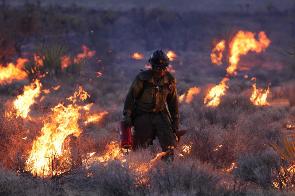 Crane Valley Hotshots set a back fire as the York fire burns in the Mojave National Preserve on July 30, 2023. The York Fire has burned over 70,000 acres, including Joshua trees and yucca in the Mojave National Preserve, and has crossed the state line from California into Nevada.