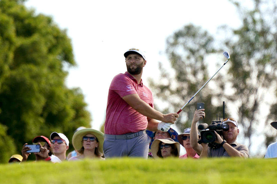 Jon Rahm, of Spain, plays his shot from the 11th tee during the final round of the Tournament of Champions golf event, Sunday, Jan. 9, 2022, at Kapalua Plantation Course in Kapalua, Hawaii. (AP Photo/Matt York)