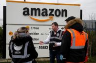 Amazon employees on strike gather outside the Amazon logistics center in Lauwin-Planque