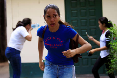 A student from the Universidad Agraria (UNA) public university looks on after washing her face of tear gas received during a protest against reforms that implement changes to the pension plans of the Nicaraguan Social Security Institute (INSS) in Managua, Nicaragua April 19,2018. REUTERS/Oswaldo Rivas