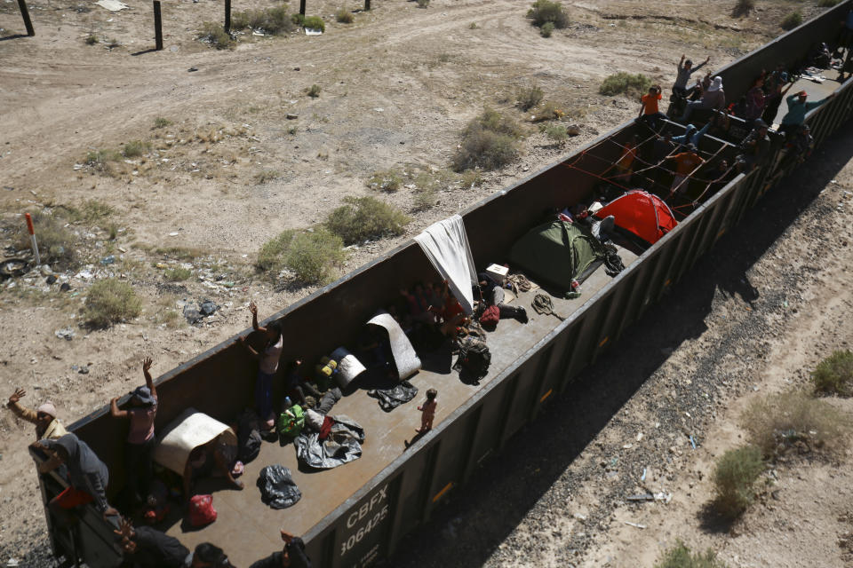 Migrants travel on a freight train, arriving in Ciudad Juarez, Mexico, Thursday, Sept. 28, 2023. (AP Photo/Christian Chavez)