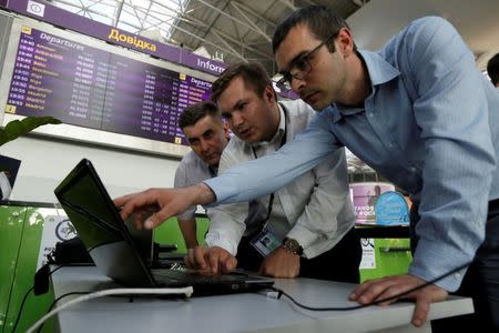 FILE PHOTO: Technicians work on a flight timetable for the airport's site at the capital's main airport, Boryspil, outside Kiev, Ukraine, June 27, 2017. REUTERS/Valentyn Ogirenko/File Photo