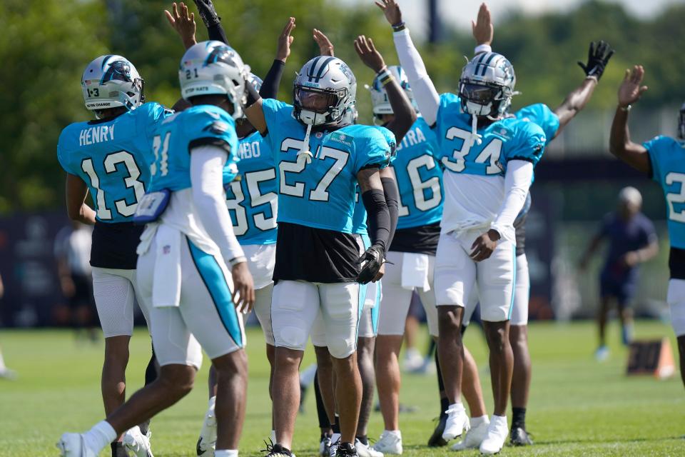 Carolina Panthers safety Kenny Robinson (27) exchanges high fives with teammates during a NFL football joint practice with the New England Patriots, Tuesday, Aug. 16, 2022, in Foxborough, Mass.