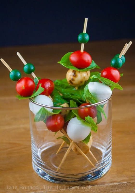 <p>The Heritage Cook</p><p>Each skewer has two cherry tomatoes and two bocconcini, separated by fresh basil leaves... it's the perfect party bite.</p><p><strong>Get the recipe: <a href="https://theheritagecook.com/mozzarella-tomato-caprese-skewers-gluten-free/" rel="nofollow noopener" target="_blank" data-ylk="slk:Caprese Skewers;elm:context_link;itc:0;sec:content-canvas" class="link ">Caprese Skewers</a></strong></p>