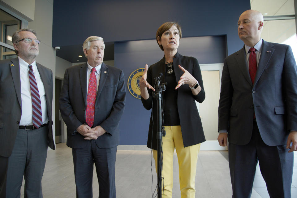 Iowa Gov. Kim Reynolds, second right, Nebraska Gov. Pete Ricketts, right, Missouri Gov. Mike Parson, and Kansas Lt. Gov. Lynn Rogers, left, face reporters following a meeting in Council Bluffs, Iowa, Friday, April 26, 2019, with officials from the U.S. Army Corps of Engineers and the Federal Emergency Management Agency to discuss the aftermath of the recent flooding along the Missouri River. (AP Photo/Nati Harnik)