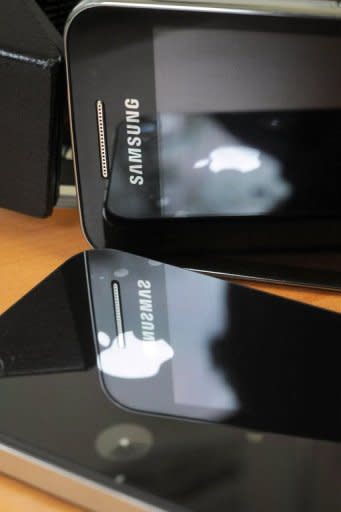 This file illustration photo shows a Samsung phone (up) and an iPhone 4. A top Samsung executive on Monday testified that he found "very offensive" the suggestion that the South Korean gadget giant ripped-off Apple's market-leading mobile iPhone and iPad devices