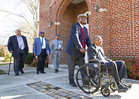 Friendship Nine members Clarence Graham, Willie E. McCloud, Willie Thomas Massey, David Williamson Jr. and James F. Wells (L-R) make their way down a street in Rock Hill, South Carolina, December 17, 2014. REUTERS/Jason Miczek