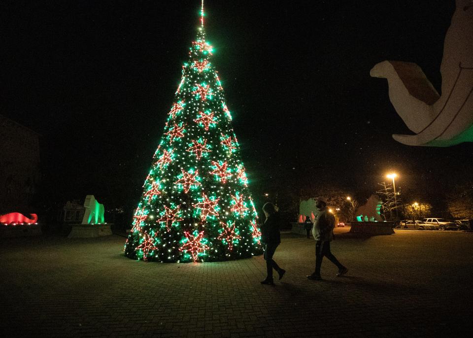 People stroll through Zoo lights, a holiday season event at the Memphis Zoo on Friday, Dec. 6, 2019.