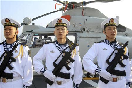 Chinese sailors stand at attention as the Chinese frigate Yancheng comes in to dock at Limassol port, January 4, 2014. REUTERS/Andreas Manolis