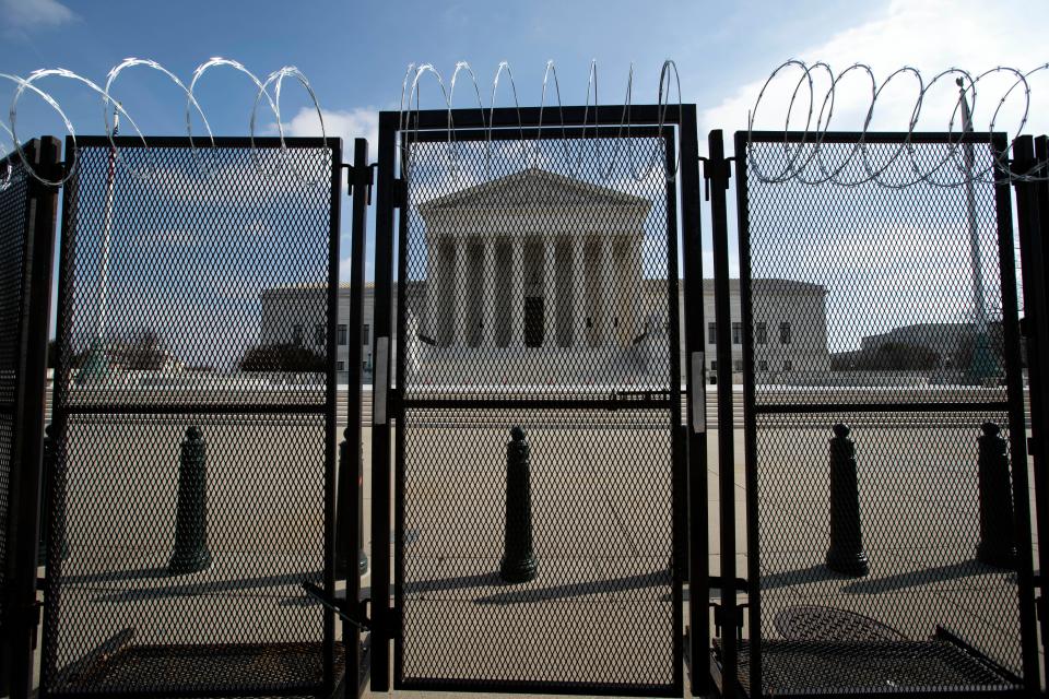 The U.S. Supreme Court is seen through a fence with barbed wire, Wednesday, Feb. 10, 2021 in Washington, as the second impeachment trial of former President Donald Trump continues at the Capitol. (AP Photo/Jose Luis Magana) ORG XMIT: DCJL112