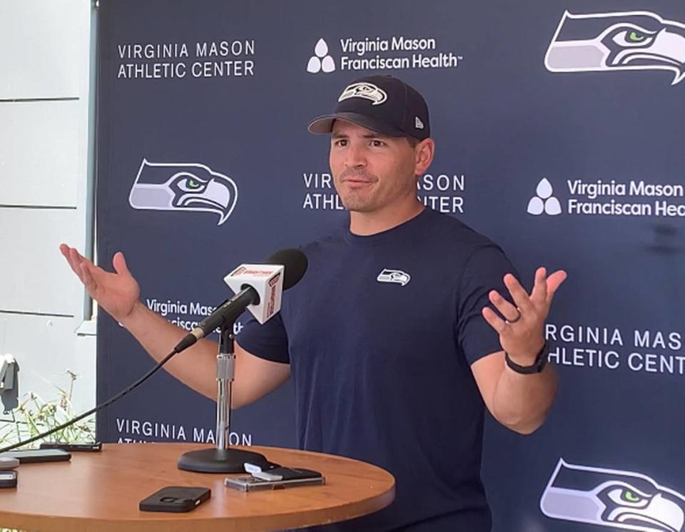 Coach Mike Macdonald as his Seahawks players are cheering for him following practice Aug. 29, 2024, at the Virginia Mason Athletic Center in Renton. Macdonald had just canceled meetings following practice, sending players off on a three-day holiday break.