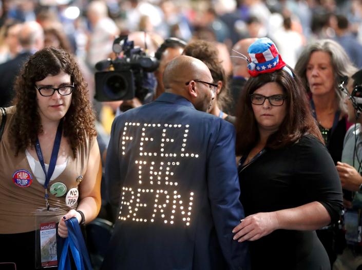 In a July 2016 photo, Florida delegate Sanjay Patel of Satellite Beach wears an illuminated jacket supporting former Democratic presidential candidate Bernie Sanders during the first day of the Democratic National Convention in Philadelphia. His wife, Stacey, who was also a delegate, is at right.