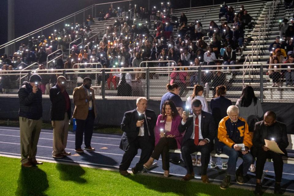 Family, friends and community members wave cellphones during a candlelight vigil in honor of three Gautier High School graduates at Gautier High School in Gautier on Thursday, Dec. 7, 2023. Se’Dhari Saniya Watson-Person, Kyla “Muffin” Watkins, and Tatyanna Richmond were involved in a fatal crash on Tuesday, leading to the deaths of Watson-Person and Watkins.