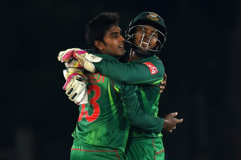 Bangladesh wicketkeeper Mushfiqur Rahim (R) and cricketer Mehedi Hasan celebrate after Rahim dismissed Sri Lankan batsman Dinesh Chandimal during their first one day international (ODI) in Dambulla on March 25, 2017