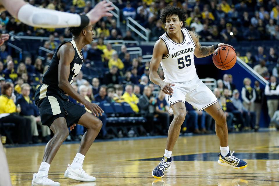 Michigan guard Eli Brooks dribbles against Purdue guard Eric Hunter Jr. during the first half at Crisler Center in Ann Arbor, Thursday, Jan. 9, 2020.