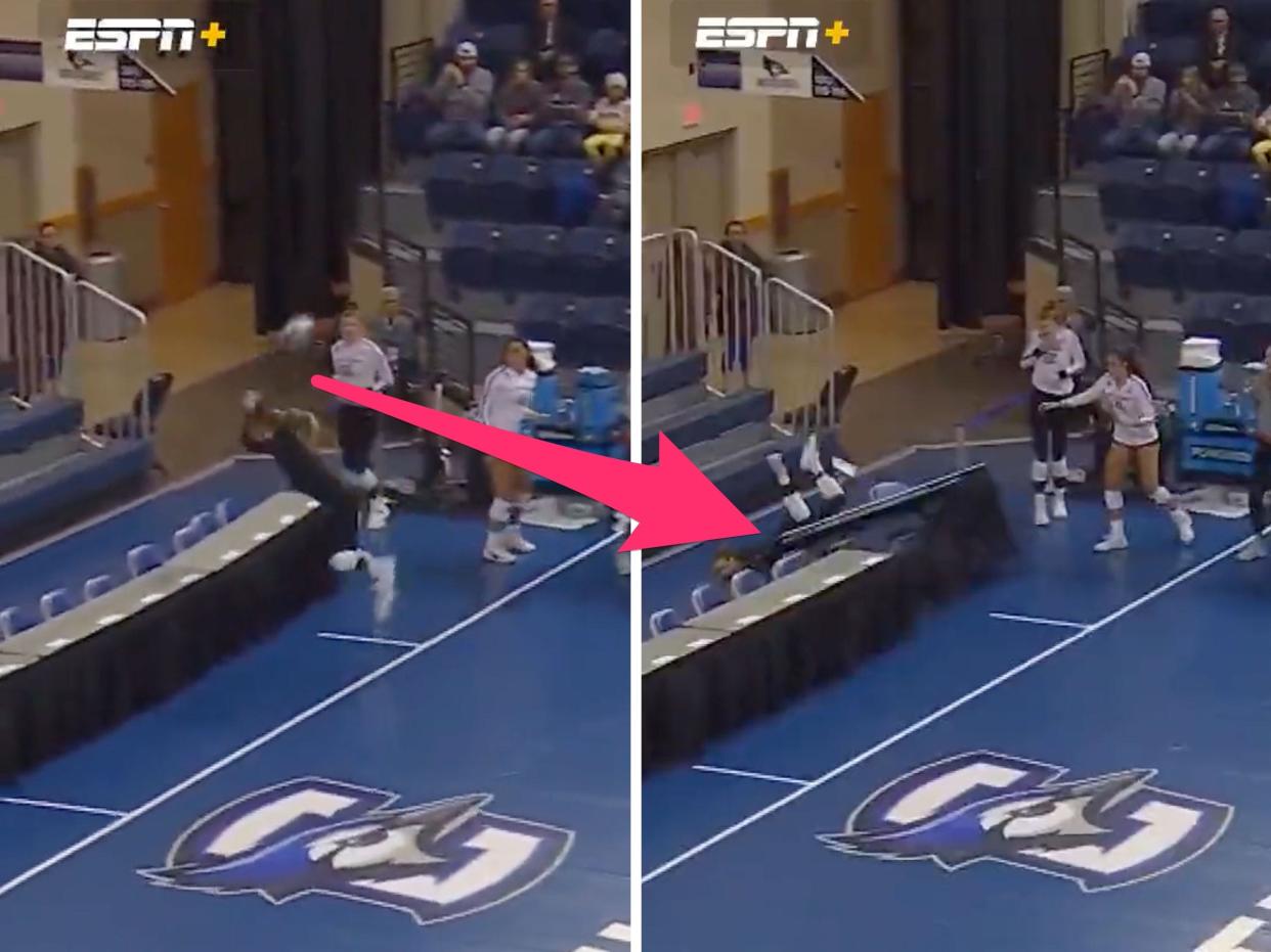 Houston Cougars libero Kate Georgiades flips over a table during a marathon point.