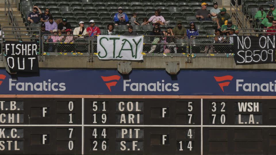 Fans sit behind signs referencing plans for the Oakland Athletics to move to Las Vegas during a game against the Atlanta Braves at RingCentral Coliseum on May 29, 2023. - Loren Elliott/Getty Images