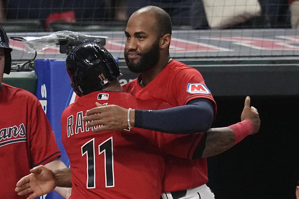 Cleveland Guardians' Amed Rosario, right, hugs Jose Ramirez (11) after Ramirez's home run against the Kansas City Royals during the sixth inning of a baseball game Thursday, July 6, 2023, in Cleveland. (AP Photo/Sue Ogrocki)