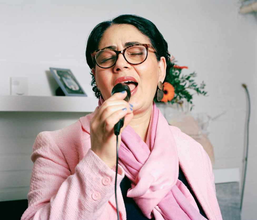 A woman singing into a microphone