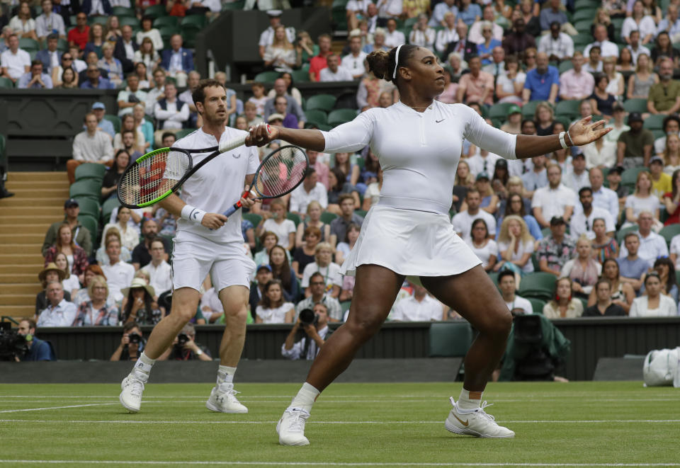 United States' Serena Williams returns the ball during a mixed doubles match with Britain's Andy Murray on day eight of the Wimbledon Tennis Championships in London, Tuesday, July 9, 2019. (AP Photo/Kirsty Wigglesworth)