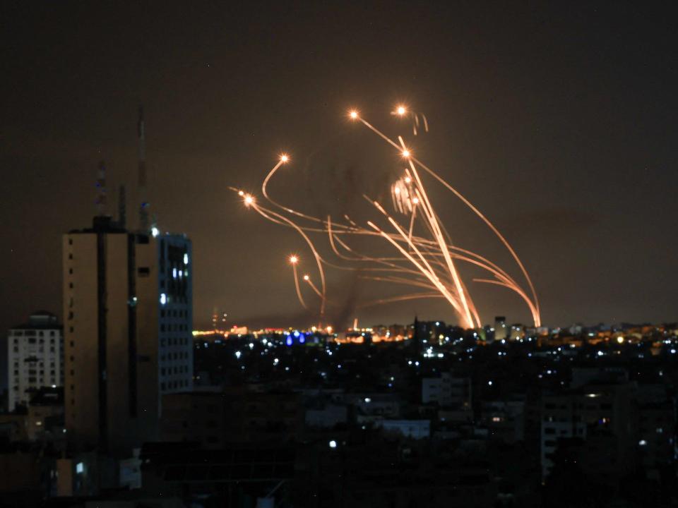 A photo of rockets intercepting each other in the night sky.