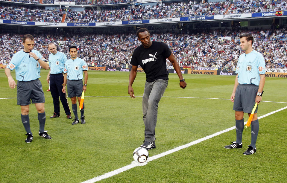 Usain Bolt before a Real Madrid game. He has always dreamed of playing soccer, specifically for Manchester United. (Getty)