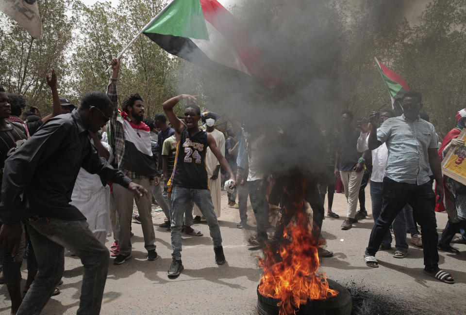 Sudanese burn tires during a demonstration to commemorate the third anniversary of a deadly crackdown carried out by security forces on protesters during a sit-in outside the army headquarters, in Khartoum, Sudan, Friday, June 3, 2022. Talks aiming at ending Sudan’s ongoing political deadlock began Wednesday, June 8, 2022, the United Nations said, although the country's main pro-democracy alliance is boycotting them over a continued police crackdown on those protesting last October's military coup. (AP Photo/ Marwan Ali)