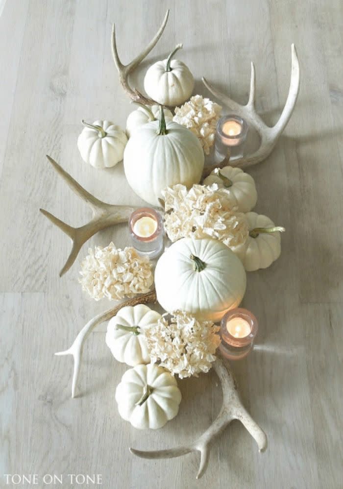 <p>Pale-colored pumpkins, antlers, dried hydrangeas, and votive candles come together to create a stunningly simple centerpiece. </p><p><strong>See more at <a rel="nofollow noopener" href="http://toneontoneantiques.blogspot.com/2015/09/fall-accents.html" target="_blank" data-ylk="slk:Tone on Tone;elm:context_link;itc:0;sec:content-canvas" class="link ">Tone on Tone</a>.</strong></p>