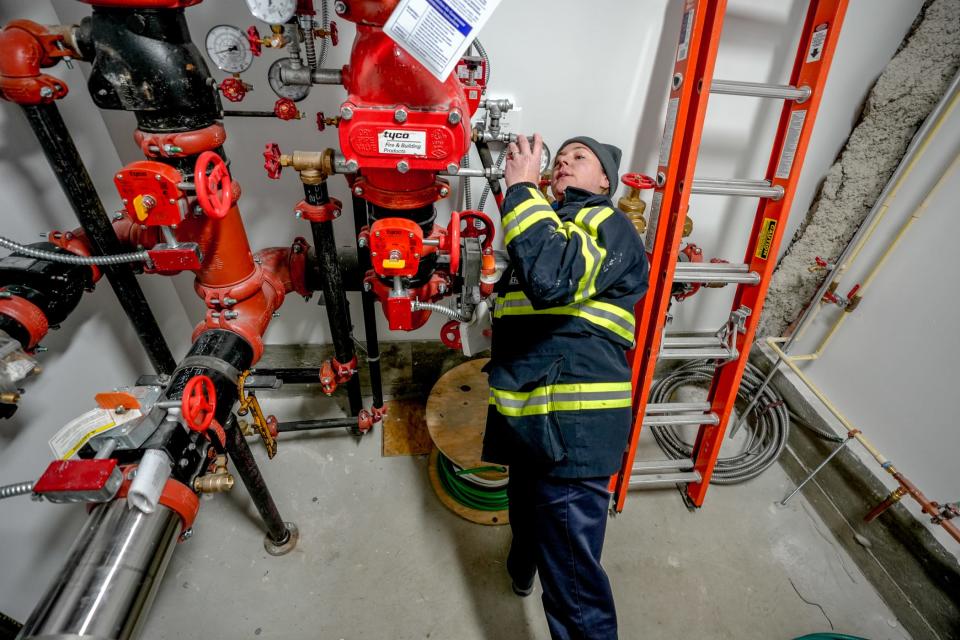 The Providence Fire Department's Jacqueline Davis inspects the sprinkler room at a new storage facility in the city.