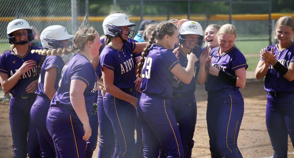 Watertown's Sarita Stevenson (third from right with helmet) enjoys the moment with teammates after she hit a three-run homer in the eighth inning of the Arrows' 18-13 Class AA SoDak 16 state-qualifying softball victory on Wednesday, May 22 in Brookings.