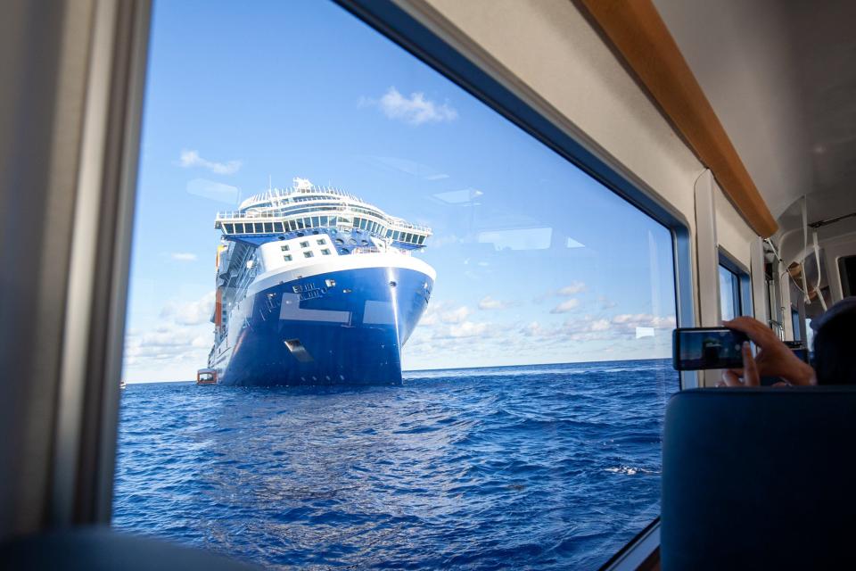 The Celebrity Apex cruise ship at sea as photographed through the window of a tender