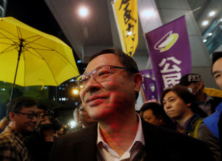 Benny Tai, a founder of the Occupy Central movement, surrounded by supporters, walks into the police headquarters in Hong Kong, China March 27, 2017. REUTERS/Bobby Yip