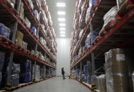 A worker moves boxes at Snowman Logistics, India's largest cold storage company in Taloja, on the outskirts of Mumbai, India, Saturday, Oct. 17, 2020. The vaccine cold chain hurdle is just the latest disparity of the pandemic weighted against the poor, who more often live and work in crowded conditions that allow the virus to spread, have little access to medical oxygen vital to COVID-19 treatment, and whose health systems lack labs, supplies or technicians to carry out large-scale testing. (AP Photo/Rajanish Kakade)