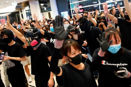 Anti-government protesters gather during a sit-in at Yoho mall, at Yuen Long MTR station, in Hong Kong