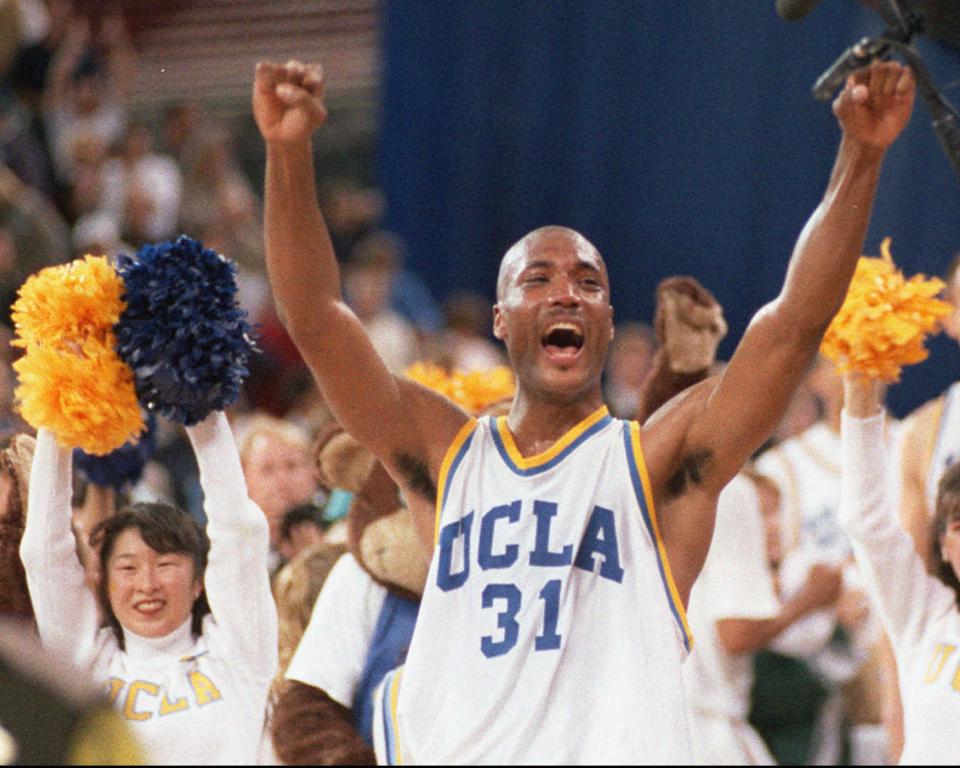 FILE - In this April 3, 1995 photo, UCLA's Ed O'Bannon celebrates after his team won the championship NCAA game against Arkansas in Seattle. O'Bannon is fond of his days at UCLA, and proud of his accomplishments. But even then he knew something wasn't right about a system that offered little more than room and board and books for his services. (AP Photo/Eric Draper, Draper)