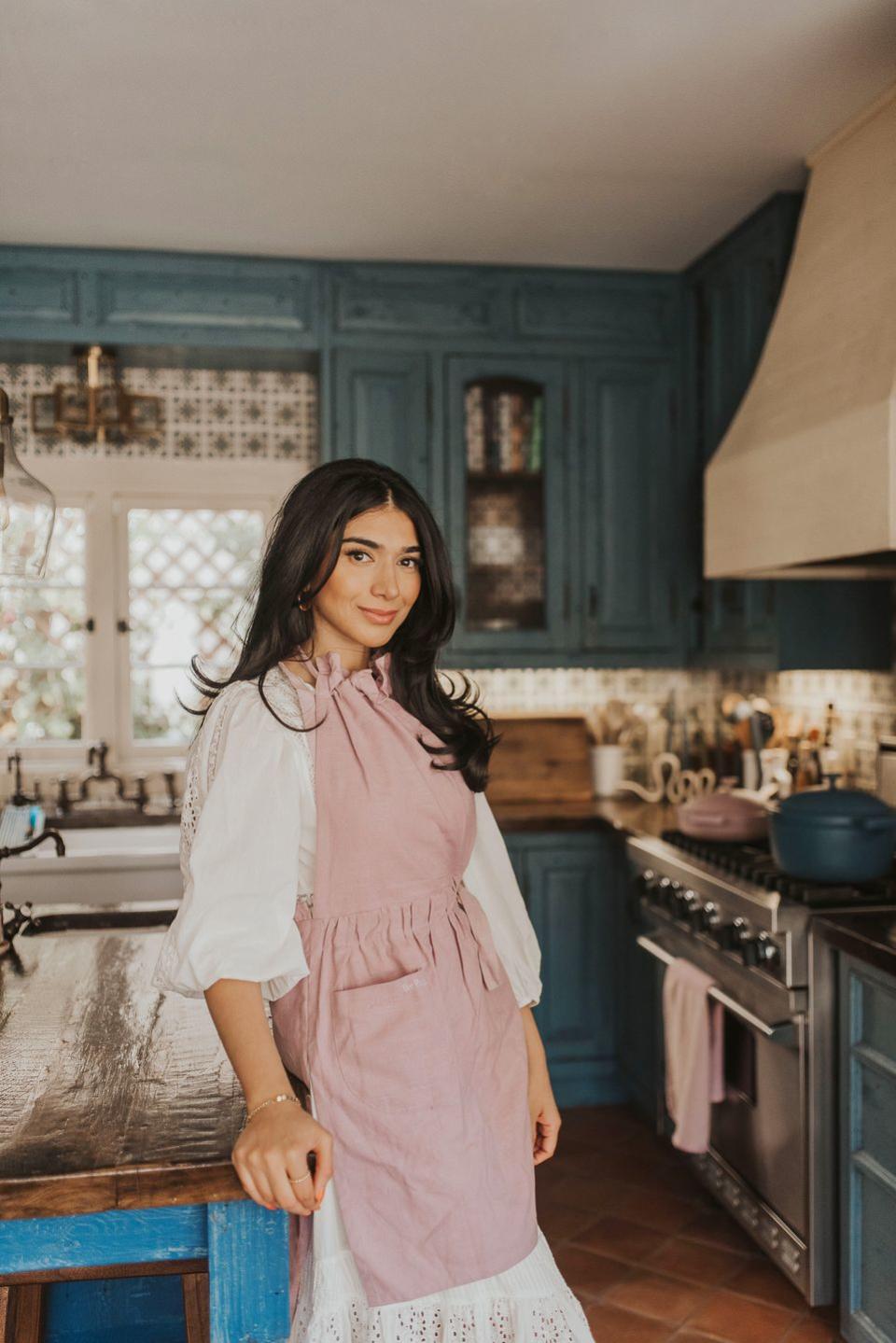 a woman standing in a kitchen