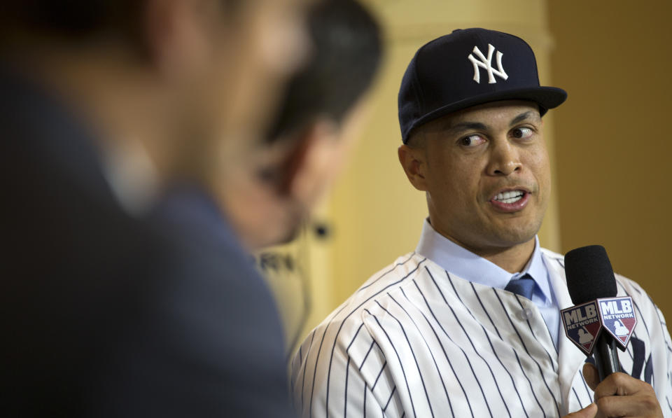 New Yankee Giancarlo Stanton talks with reporters on set during the Major League Baseball winter meetings in Orlando, Fla., Monday, Dec. 11, 2017. (AP)