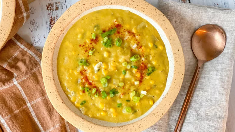 Corn chowder in bowl with spoon