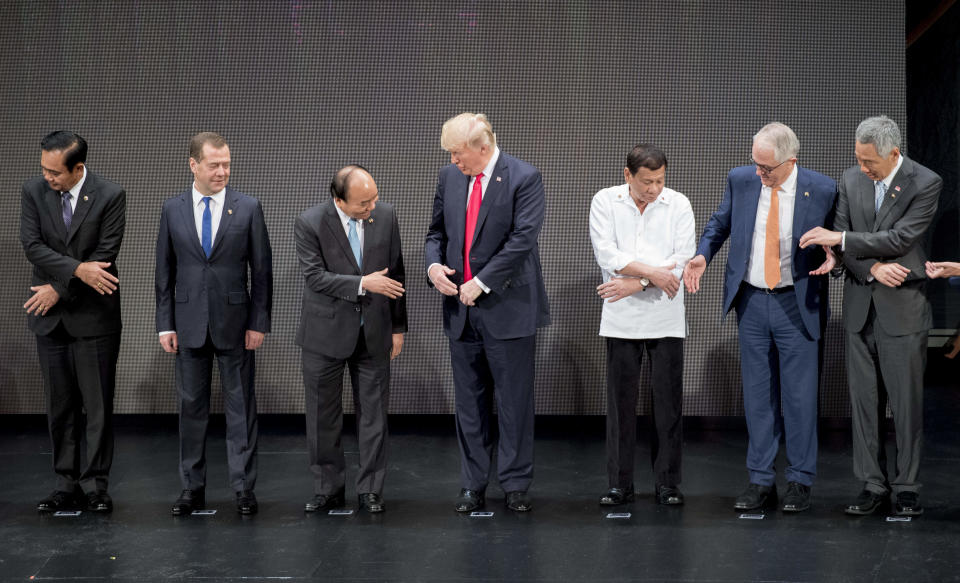 2. World leaders begin to take each other's hands. Trump turns to &nbsp;Vietnam's Prime Minister Nguyen Xuan Phuc.