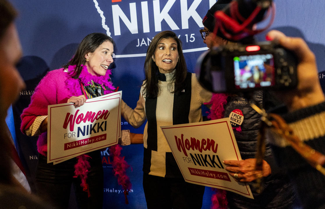 Nikki Haley appears at a campaign event in Ames, Iowa, surrounded by supporters. 