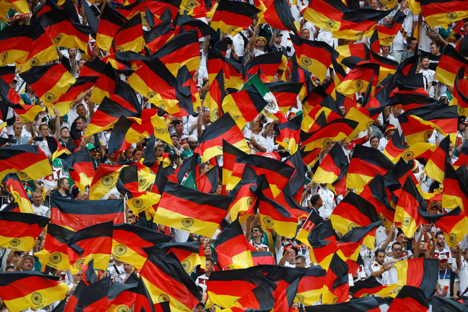 <p>Germany fans fly the flag as their team enter the pitch </p>