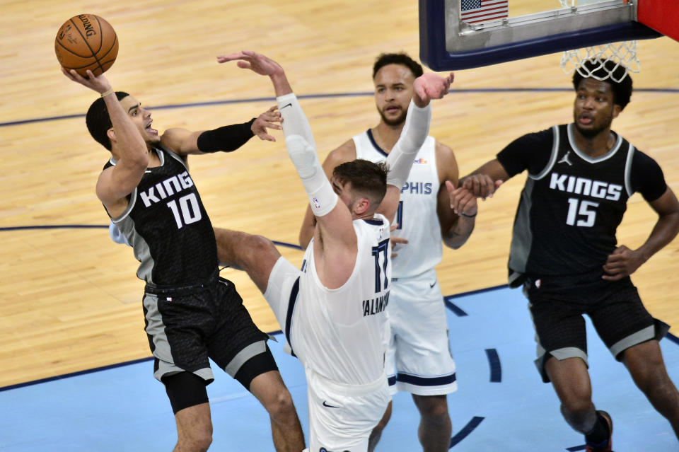 Sacramento Kings guard Justin James (10) shoots against Memphis Grizzlies center Jonas Valanciunas (17) as forward Kyle Anderson (1) and center Damian Jones (15) move for position in the second half of an NBA basketball game Thursday, May 13, 2021, in Memphis, Tenn. (AP Photo/Brandon Dill)