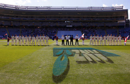 Cricket - Test Match - New Zealand v England - Eden Park, Auckland, New Zealand, March 22, 2018. The New Zealand and England teams stand together for their national anthems before the start of the first day of the first cricket test match. REUTERS/David Gray