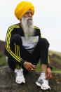 EDINBURGH, SCOTLAND - SEPTEMBER 01: Centenarian Sikh runner Fauja Singh poses for pictures after being the first person to officially enter for next year's Edinburgh Marathon on September 1, 2011 in Edinburgh, Scotland. A world record holder, aged 100, Fajua Singh has run seven marathons, all after his 89th birthday. He officially opened the entry process by signing up for his last ever 26 mile event in Edinburgh. (Photo by Jeff J Mitchell/Getty Images)